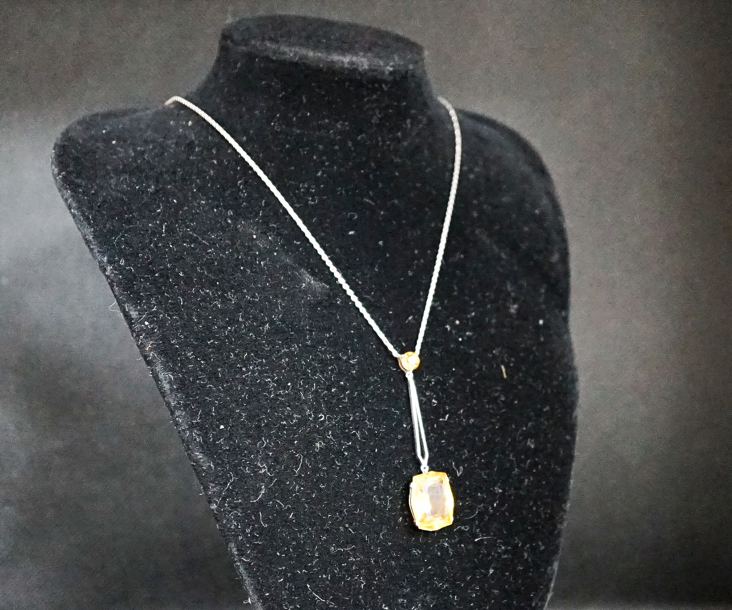 A white metal and two stone citrine set drop line pendant necklace, pendant 45mm, chain 40cm, gross weight 4.1 grams.